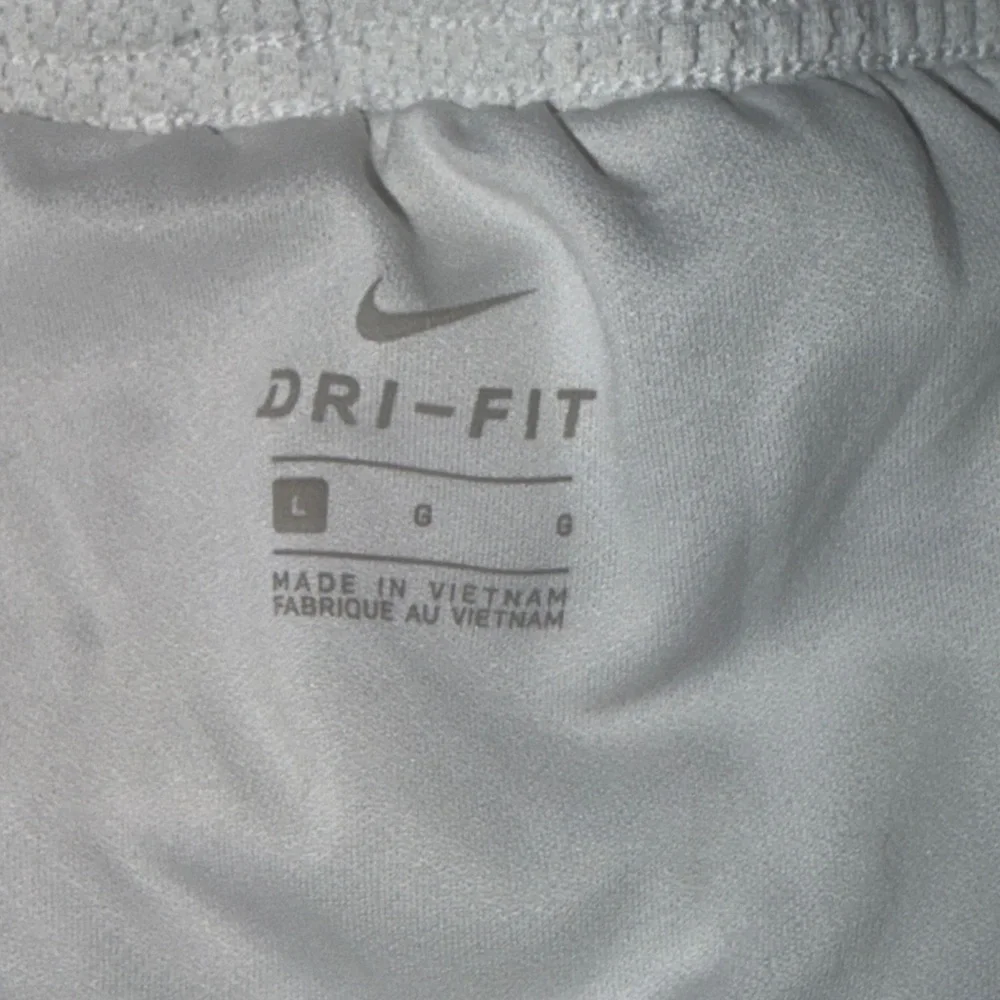 Nike Running Tempo Dri-FIT mid rise 3 inch shorts in white